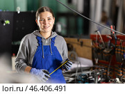 Girl glazer employee in blue overall works in glass processing shop. Стоковое фото, фотограф Яков Филимонов / Фотобанк Лори