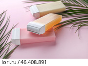 Liposoluble wax cartridges and tropical leaves on color background. Стоковое фото, фотограф Pixel_shot / Фотобанк Лори