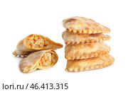 Stack of baked meat empanadas on white background. Стоковое фото, фотограф Pixel_shot / Фотобанк Лори