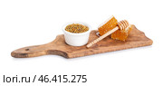 Bowl of bee pollen and honey combs on white background. Стоковое фото, фотограф Pixel_shot / Фотобанк Лори