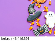 Tasty Halloween candy corns and cookies on purple background. Стоковое фото, фотограф Pixel_shot / Фотобанк Лори