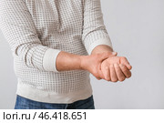 Senior man suffering from Parkinson syndrome on grey background. Стоковое фото, фотограф Pixel_shot / Фотобанк Лори