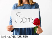 Woman holding paper with word SORRY on white background, closeup. Стоковое фото, фотограф Pixel_shot / Фотобанк Лори