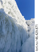 Baikal Lake in winter. Unusual landscape of famous icy Cape Sagan-Khushun or Three Brothers rocks are natural landmark of Olkhon Island. View of long icicles and amazing ice crust. Natural background. Стоковое фото, фотограф Виктория Катьянова / Фотобанк Лори