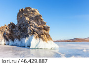 Winter landscape of frozen Baikal Lake. View of Dragon Cape on edge of Ogoy Island - natural landmark against background of blue sky in sunny cold day. Nature background. Winter travels and outdoors. Стоковое фото, фотограф Виктория Катьянова / Фотобанк Лори