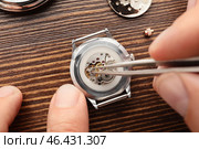 Clockmaker repairing broken watch at table, closeup. Стоковое фото, фотограф Pixel_shot / Фотобанк Лори