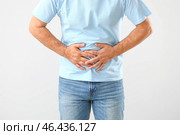 Зрелый человек страдает от боли в животе на белом фоне. Стоковое фото, фотограф Pixel_shot / Фотобанк Лори