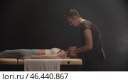 Osteopath gently manipulating patient's neck on massage table. Стоковое видео, видеограф Константин Шишкин / Фотобанк Лори