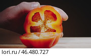 A closeup view of a hand skillfully cutting a fresh, ripe tomato using a sharp knife. Стоковое видео, видеограф Владимир Ковальчук / Фотобанк Лори