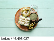 Чаша с вкусным сыром фета, маслом и оливками на цветном деревянном фоне. Стоковое фото, фотограф Pixel_shot / Фотобанк Лори