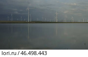 Windmills turbines with water reflection. Стоковое видео, видеограф Михаил Коханчиков / Фотобанк Лори