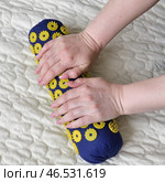 Women's palms on a needle roller - foot massage using an applicator Kuznetsov, Russia. Стоковое фото, фотограф Володина Ольга / Фотобанк Лори