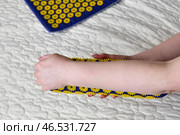 Women's forearm on a needle roller - foot massage using an applicator Kuznetsov, Russia. Стоковое фото, фотограф Володина Ольга / Фотобанк Лори