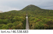 Russia, Stavropol Territory, the city of Zheleznovodsk September 29 2022, Iron Mountain from foot to top is covered with dense deciduous forest. Cascading staircase tends to the top of the mountain. Стоковое видео, видеограф Скрипачев Антон / Фотобанк Лори