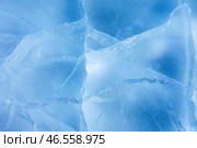 Beautiful natural ice texture of frozen Baikal Lake in cold winter day. Blue ice surface with pattern of white cracks. Nature winter background.  Mock up, copy space, flat lay, blank, close-up. Стоковое фото, фотограф Виктория Катьянова / Фотобанк Лори