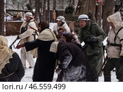 Sestroretsk, Russia - February 19, 2023: In a snowy forest during World War II, soldiers and civilians navigate the struggles of wartime, evoking strong emotions of resilience and despair. Редакционное фото, фотограф Aleksandr Golubev / Фотобанк Лори