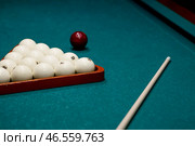 Russian billiards. Red and white balls are lying on a green billiard table. Spending time at home playing a hobby sports game. Стоковое фото, фотограф Photojuli / Фотобанк Лори