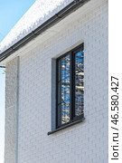 A house with white clinker brick facade and window. Стоковое фото, фотограф Наталья Симакова / Фотобанк Лори