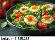 A fresh salad of soft-boiled eggs, halved and with tender, slightly dripping yolks. They are laid on a bed of greens, including arugula and spinach. Among the leaves are juicy cherry tomato halves, as well as nuts and seeds, which add texture. The salad is seasoned with black pepper and perhaps a drizzle of balsamic vinegar or olive oil. The photo is done in the aesthetic style of food photography, with an emphasis on the freshness of the ingredients and the contrast of the colors. Стоковое AI-изображение, AI-художник Анна Кривицкая / Фотобанк Лори