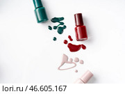 Bright colored nail polish bottles with drippings on white background. Стоковое фото, фотограф Сергей Толмачёв / Фотобанк Лори