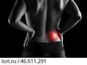 Back pain, kidney inflammation, woman suffering from backache on black background. Стоковое AI-изображение, AI-художник Станислав Тарко / Фотобанк Лори