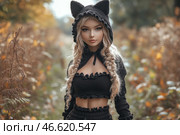 A girl in the forest, wearing a black hoodie with cat ears. She has long blonde hair, braided into two braids, and an expression that combines innocence and confidence. The girl stands against a background of autumn trees, which gives the picture a warm atmosphere. Her clothes with ruffles and a light, elegant design emphasize style and personality, while the forest landscape and soft light create a secluded, slightly magical atmosphere. Стоковое AI-изображение, AI-художник Анна Кривицкая / Фотобанк Лори