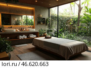 The interior of a cozy bathroom or spa treatment, filled with natural elements. The room has a large glass wall through which a green garden with plants is visible. In the center there is a bed covered with a soft blanket, next to it is a tray with cosmetics. Also visible are two sinks with black faucets and neatly folded towels on the shelves. The atmosphere of calm and comfort is created by plants, soft lighting and neutral tones in the interior. Стоковое AI-изображение, AI-художник Анна Кривицкая / Фотобанк Лори