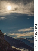 A moonlit landscape with mountains, clouds, and a bright moon. Stars are visible in the night sky. Стоковое фото, фотограф Воловодов Владимир / Фотобанк Лори