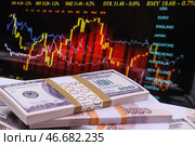 Пачки банкнот номиналом 100 долларов США и 5000 российских рублей на фоне графика. Стоковое фото, фотограф Сергей Булкин/NEWS.ru / ТАСС / Фотобанк Лори