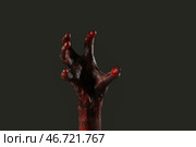 Рука зомби на черном фоне. Празднование Хэллоуина. Стоковое фото, фотограф Pixel_shot / Фотобанк Лори