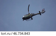 Helicopter hovering against bright sunny and cloudy sky. Стоковое фото, фотограф David Kashakhi / Фотобанк Лори