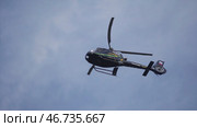 Helicopter hovering against bright sunny and cloudy sky. Стоковое фото, фотограф David Kashakhi / Фотобанк Лори