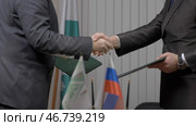 Two businessmen shaking hands indicating successfully made deal. Стоковое фото, фотограф David Kashakhi / Фотобанк Лори