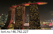 Night view Singapore skyline flying over Marina Bay Sands Hotel. Стоковое фото, фотограф David Kashakhi / Фотобанк Лори