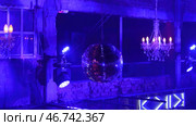Party disco ball with stars in nightclub with striped blue and black walls lit by spotlight, night life entertainment industry. Стоковое фото, фотограф David Kashakhi / Фотобанк Лори