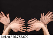 Стробоскопическое фото женских рук, двигающихся на темном фоне. Стоковое фото, фотограф Pixel_shot / Фотобанк Лори