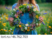 A beautiful summer wreath of wildflowers in the hands of a girl. Summer spring time. Summer solstice background. The feast of Ivan Kupala. Стоковое AI-изображение, AI-художник Photojuli / Фотобанк Лори