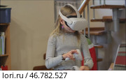 Young girl experiencing virtual reality with headset and motion controllers at home. Стоковое видео, видеограф Дмитрий Наумов / Фотобанк Лори