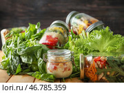 Вкусные овощные салаты в масонных банках и зелень на деревянном столе. Стоковое фото, фотограф Pixel_shot / Фотобанк Лори