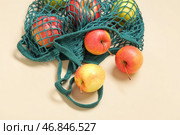 Сетчатый мешок с свежими яблоками на бежевом фоне, крупным планом. Стоковое фото, фотограф Pixel_shot / Фотобанк Лори