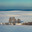 Landscape in a minimalist style. Hilly landscape covered with snow. There are dark silhouettes of trees in the foreground. A sunny winter day. Стоковое фото, фотограф Владимир Ендовицкий / Фотобанк Лори