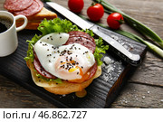 Доска с вкусным яйцом Бенедикт на деревянном фоне. Стоковое фото, фотограф Pixel_shot / Фотобанк Лори