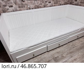 Assembled ottoman with backrest, armrests, and linen drawers. The ottoman has an orthopedic mattress on it. Стоковое фото, фотограф Vadzim Yakubovich / Фотобанк Лори