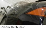 Close up for red taillight and polished car wings, vehicle body details. Редакционное фото, фотограф David Kashakhi / Фотобанк Лори
