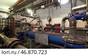 Large industrial boiler room, pipes of central heating system and water pipes with thermal insulation. Стоковое фото, фотограф David Kashakhi / Фотобанк Лори