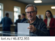 A man votes in an election, throws a ballot paper into a ballot box. Стоковое AI-изображение, AI-художник Александр Поташев / Фотобанк Лори