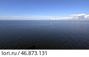 Одинокий парус в Балтийском море. Вид с палубы парома. Май. Lonely sail in the Baltic Sea. View from the ferry deck. May. Стоковое видео, видеограф Горшков Александр / Фотобанк Лори