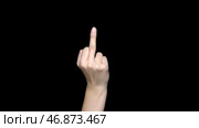 Hand sign showing middle finger in rude way meaning fuck off, isolated on black background. Стоковое фото, фотограф David Kashakhi / Фотобанк Лори
