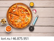 Тарелка вкусной пиццы из морепродуктов и ингредиентов на светлом деревянном фоне. Стоковое фото, фотограф Pixel_shot / Фотобанк Лори