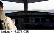 Captain in the aircraft cockpit, preparing for flight departure. Стоковое фото, фотограф David Kashakhi / Фотобанк Лори